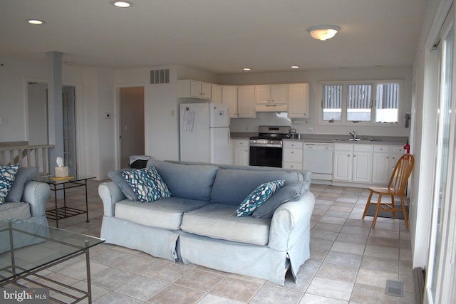 living room featuring light tile patterned floors and sink