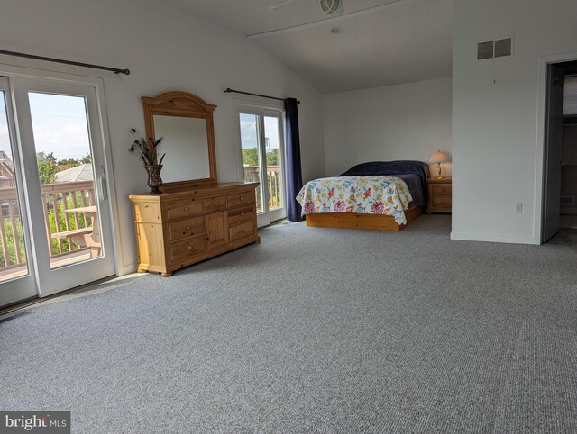 bedroom with access to exterior, lofted ceiling, and carpet floors