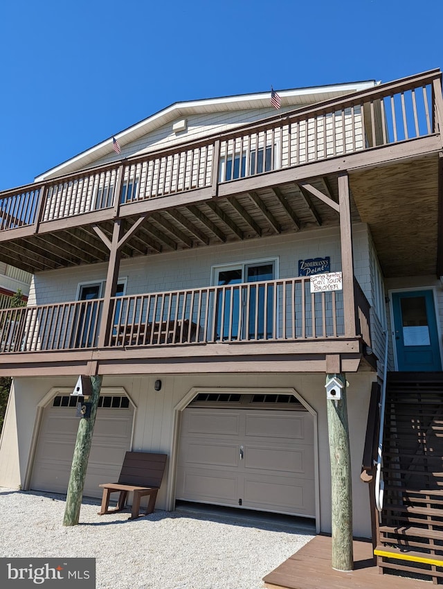 view of front facade featuring a balcony and a garage