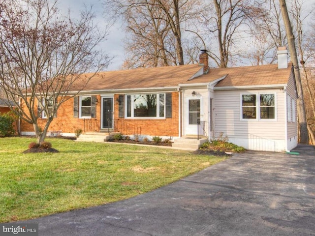 ranch-style home with a front lawn