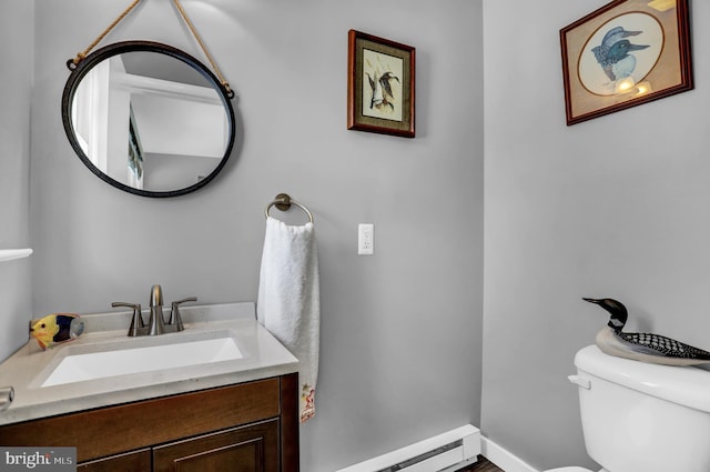 bathroom with vanity, a baseboard heating unit, and toilet