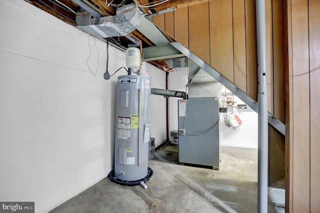 utility room with heating unit and water heater