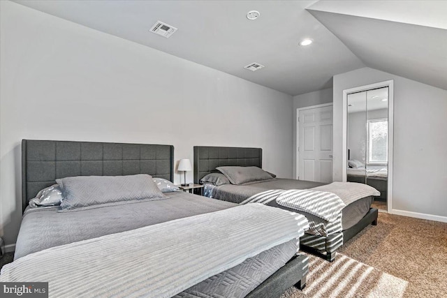 carpeted bedroom featuring a closet and lofted ceiling