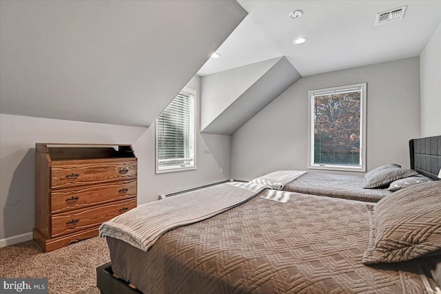 carpeted bedroom featuring lofted ceiling and a baseboard heating unit