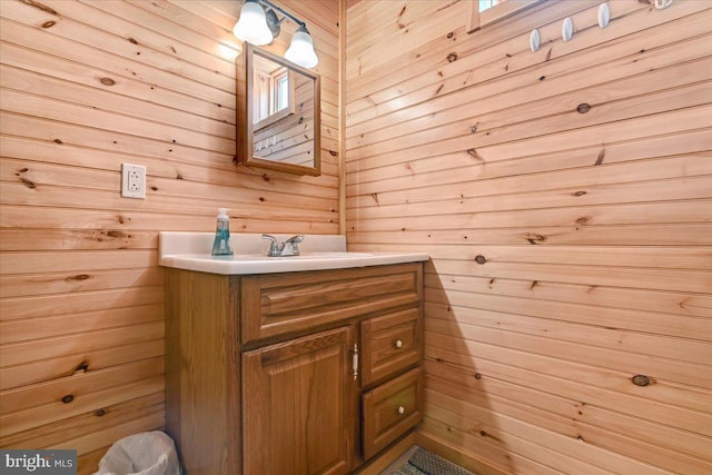 bathroom with wood walls and vanity