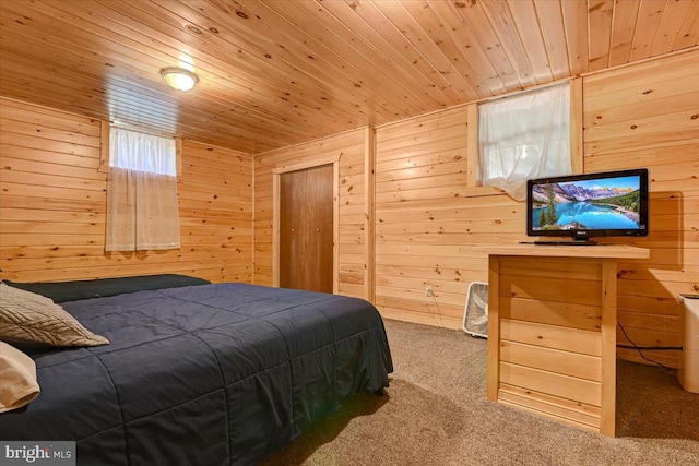 carpeted bedroom featuring wood walls and wood ceiling