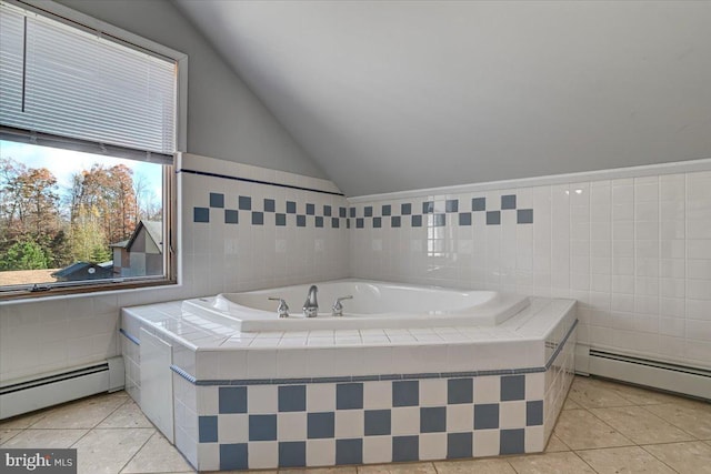 bathroom with tile patterned flooring, baseboard heating, tiled bath, and vaulted ceiling