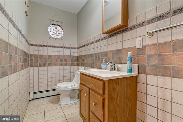 bathroom featuring tile patterned flooring, vanity, a baseboard radiator, and tile walls