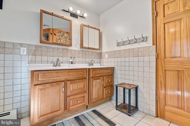 bathroom featuring tile patterned flooring, vanity, and tile walls