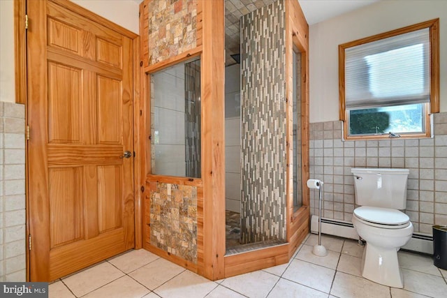 bathroom featuring tile patterned floors, tile walls, and a baseboard radiator