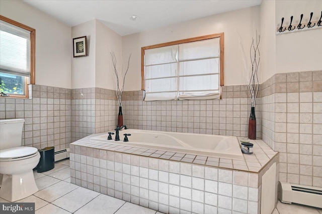 bathroom featuring tile patterned flooring, baseboard heating, and tile walls