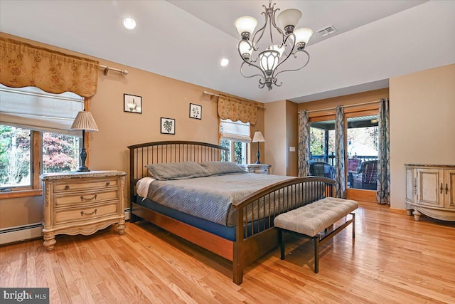 bedroom with access to outside, light hardwood / wood-style floors, and an inviting chandelier