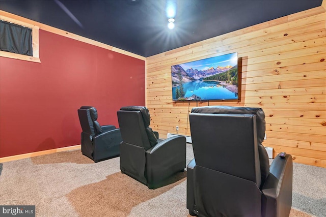 carpeted home theater featuring wooden walls