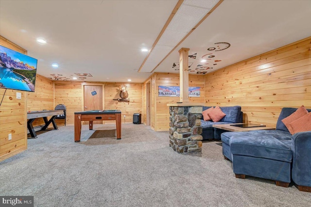 rec room with wood walls and carpet floors