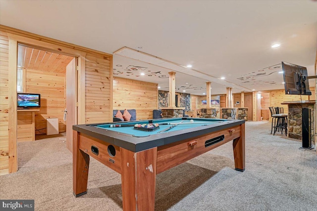 game room featuring indoor bar, light colored carpet, wooden walls, and pool table