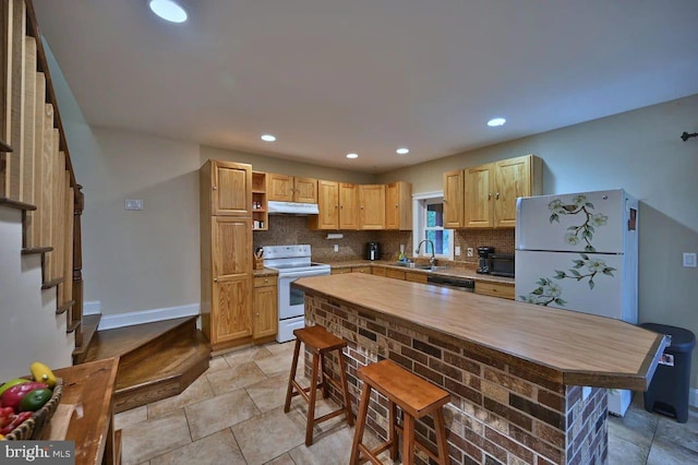 kitchen featuring backsplash, light brown cabinetry, white appliances, and sink