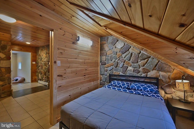 tiled bedroom featuring wood walls and wood ceiling