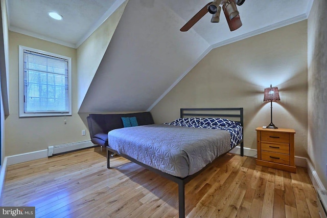 bedroom featuring ceiling fan, crown molding, a baseboard heating unit, light hardwood / wood-style floors, and lofted ceiling