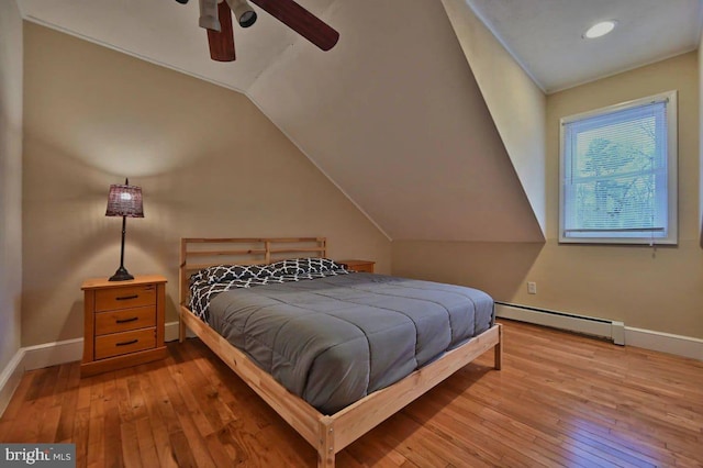 bedroom featuring ceiling fan, vaulted ceiling, light wood-type flooring, and a baseboard radiator