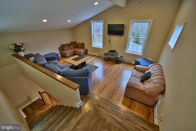 living room featuring vaulted ceiling with beams and light hardwood / wood-style floors