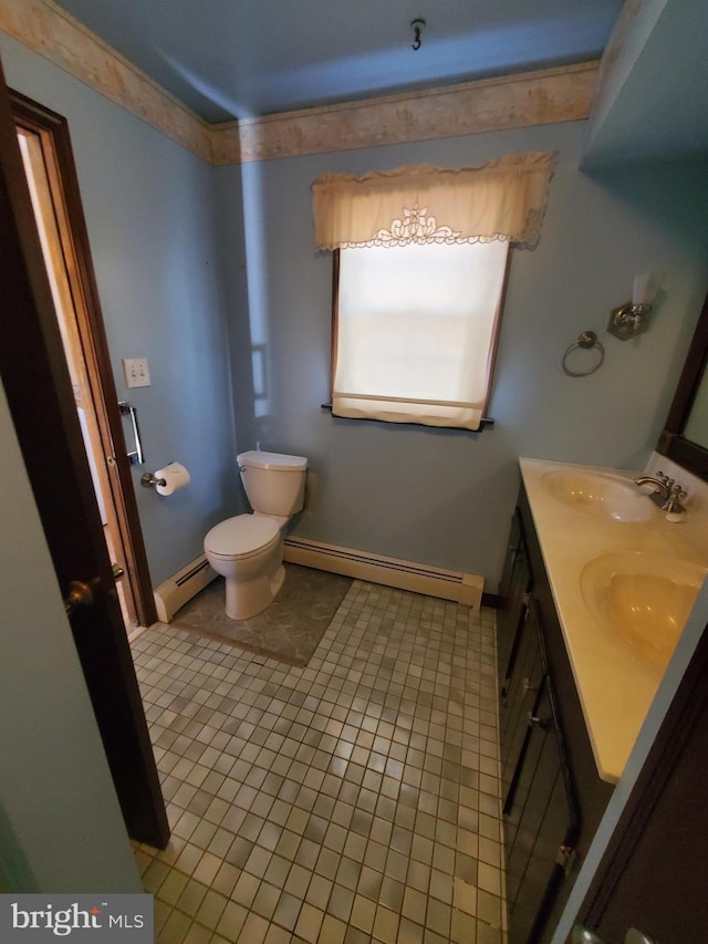 bathroom featuring baseboard heating, tile patterned floors, vanity, and toilet