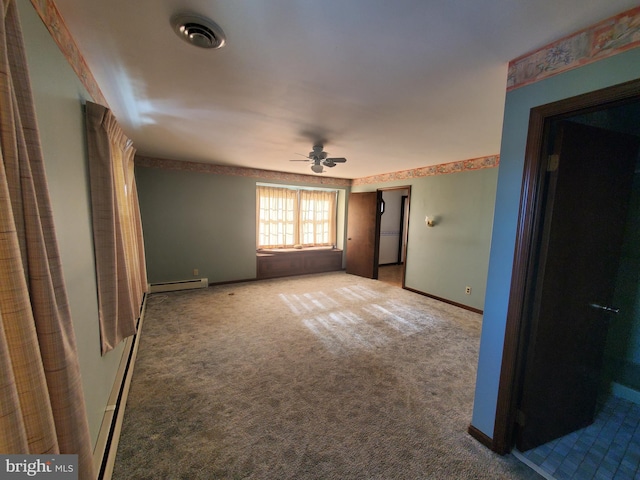 unfurnished bedroom with carpet, a baseboard heating unit, and ceiling fan