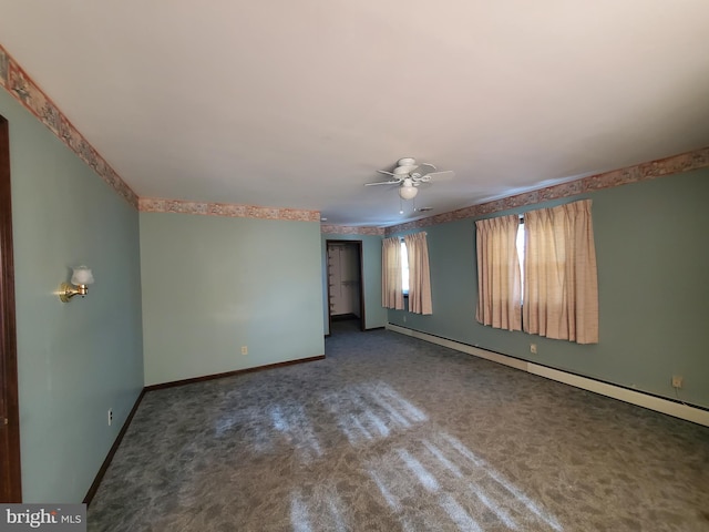 empty room featuring ceiling fan, dark carpet, and baseboard heating