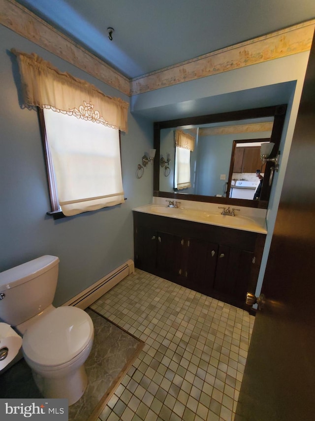 bathroom with vanity, a baseboard heating unit, tile patterned floors, and toilet