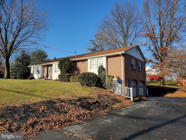 view of front of home featuring a garage and a front lawn