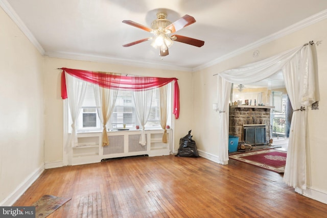 spare room featuring hardwood / wood-style flooring, ceiling fan, ornamental molding, and a wealth of natural light