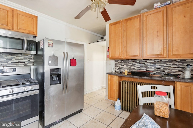 kitchen featuring crown molding, ceiling fan, light tile patterned floors, tasteful backsplash, and stainless steel appliances