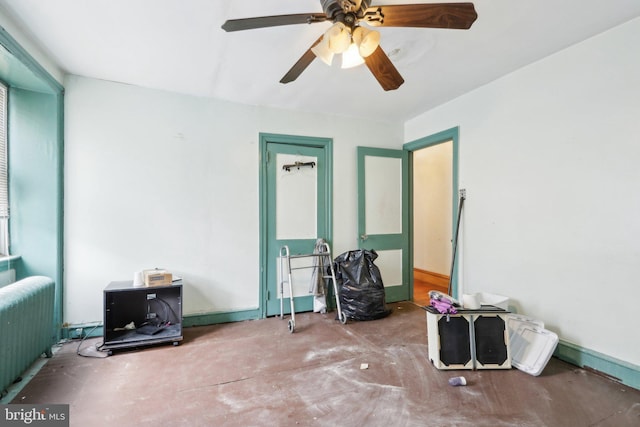 miscellaneous room with radiator, concrete floors, and ceiling fan