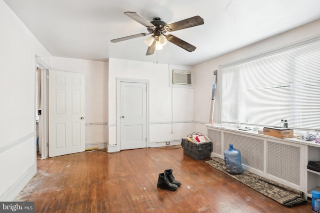 miscellaneous room with a wall mounted AC, ceiling fan, and wood-type flooring