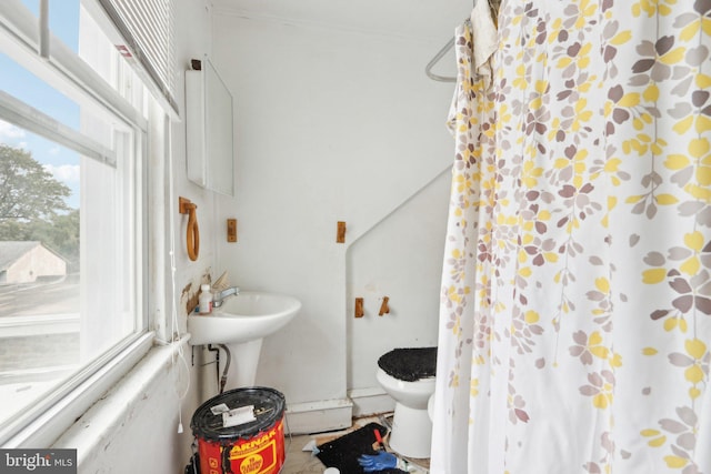 bathroom with toilet and curtained shower