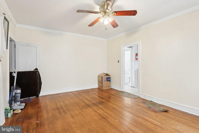 interior space with ceiling fan, wood-type flooring, and crown molding