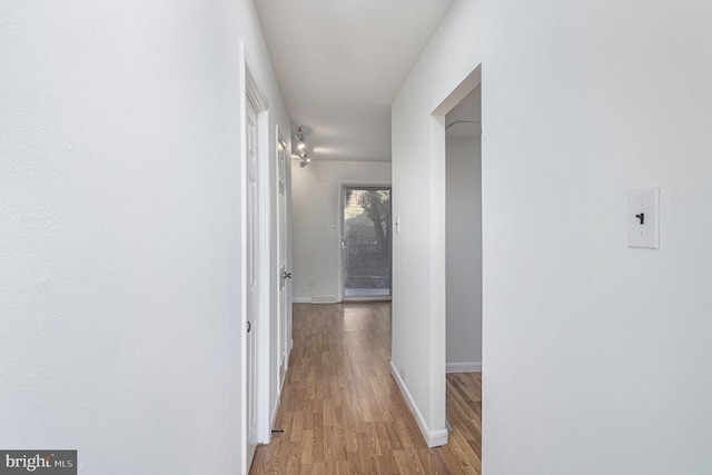 hallway with light hardwood / wood-style flooring