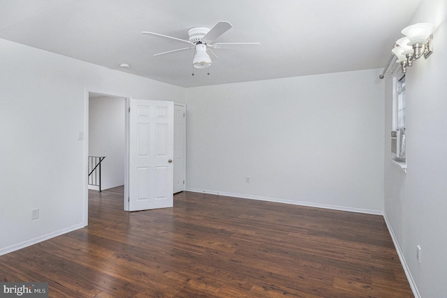 unfurnished room with dark hardwood / wood-style flooring and ceiling fan