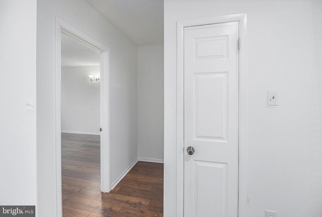 hallway with dark hardwood / wood-style floors