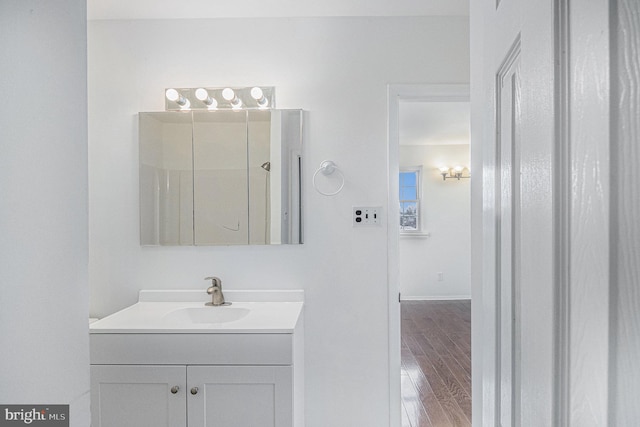 bathroom with vanity, a shower, and wood-type flooring