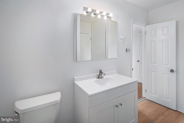 bathroom featuring hardwood / wood-style floors, vanity, and toilet