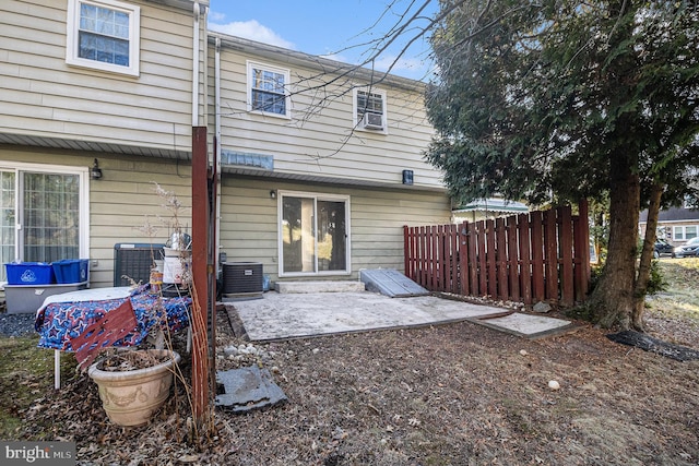 back of property featuring cooling unit and a patio