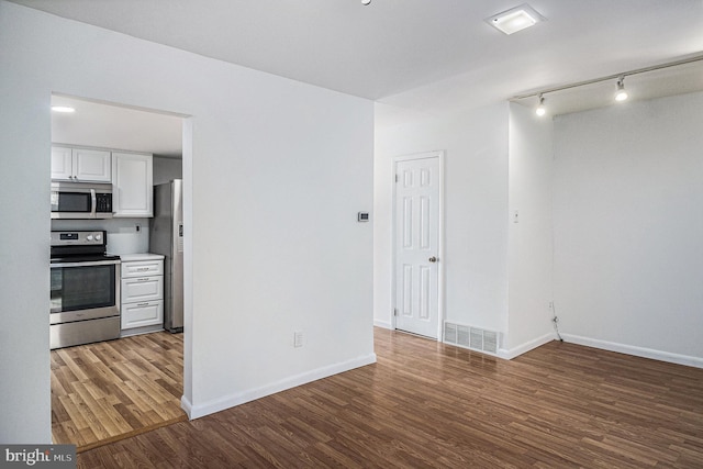 empty room with hardwood / wood-style flooring