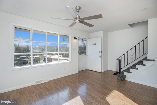 foyer with dark hardwood / wood-style floors, ceiling fan, and a healthy amount of sunlight