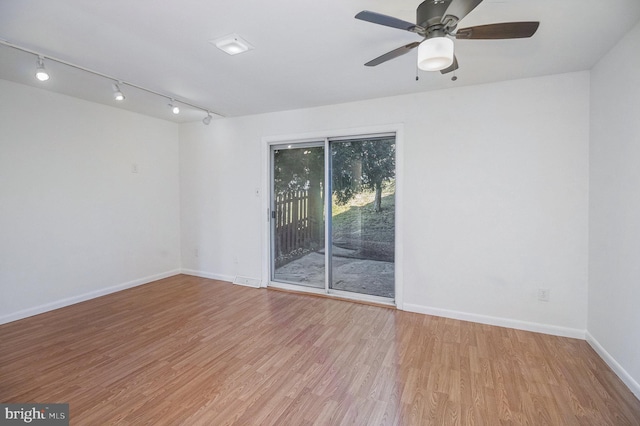 empty room with ceiling fan and light wood-type flooring