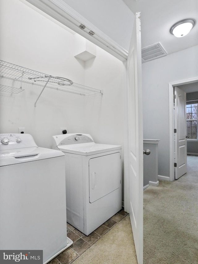 washroom featuring separate washer and dryer and carpet