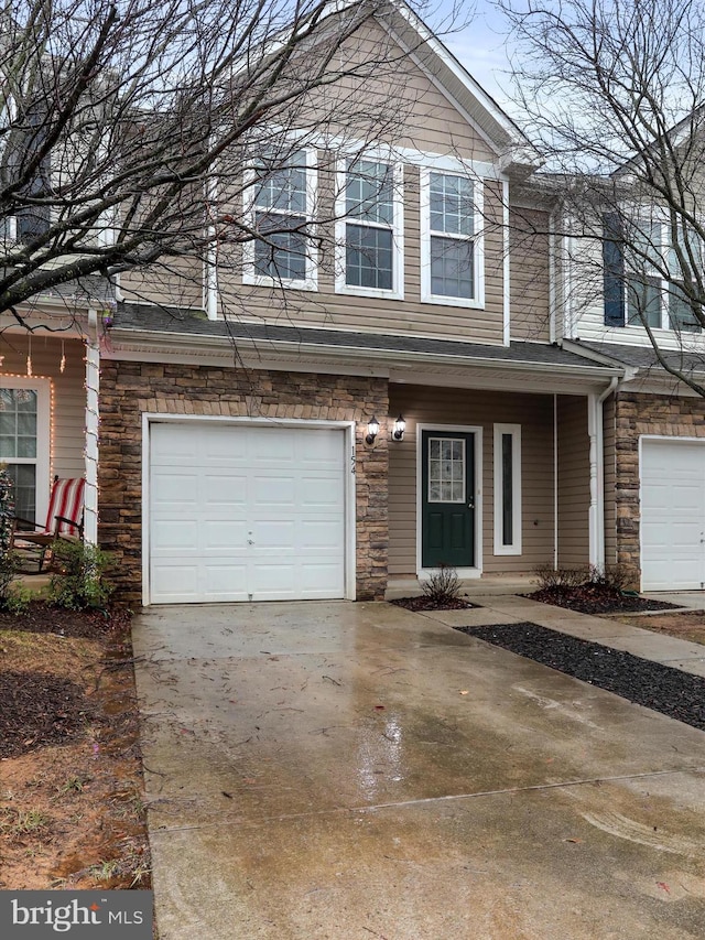 townhome / multi-family property featuring a porch and a garage