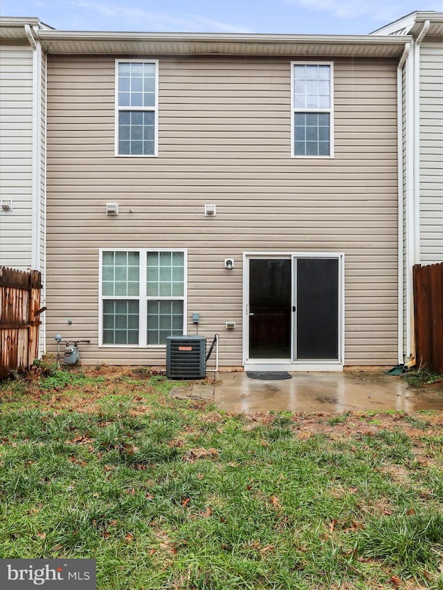 rear view of house with a yard, a patio area, and central air condition unit