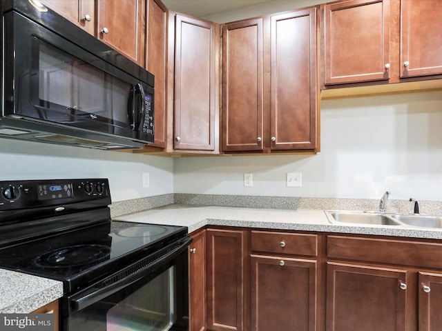 kitchen featuring black appliances and sink