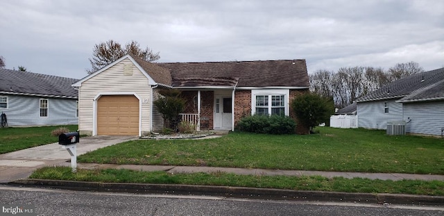 view of front of home featuring a garage, central air condition unit, and a front yard