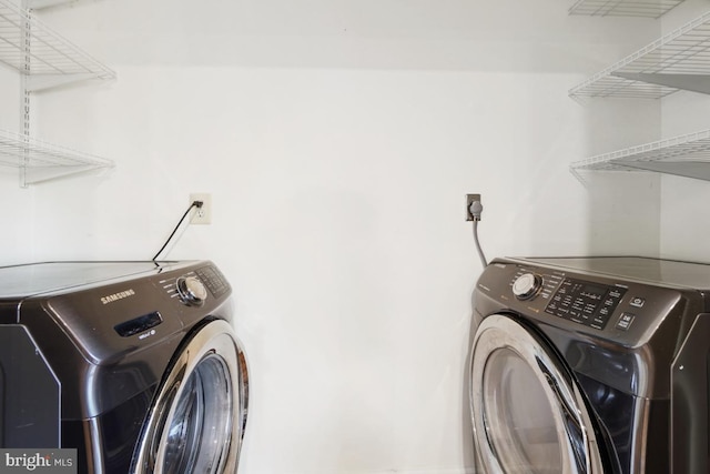 laundry room featuring washing machine and clothes dryer